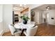 Open-concept eat-in kitchen features a modern table with kitchen in the background at 3061 S Marion St, Englewood, CO 80113