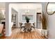 Bright dining area featuring wood floors, large window, and seating for four, adjacent to modern kitchen at 3061 S Marion St, Englewood, CO 80113