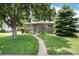 Charming single-story home with a well-manicured lawn and mature trees in a desirable neighborhood at 3061 S Marion St, Englewood, CO 80113