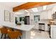 Bright kitchen with stainless appliances, skylight and quartz counters. Features breakfast bar with seating at 3061 S Marion St, Englewood, CO 80113