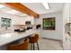 Eat-in kitchen with stainless steel appliances, wood beam and window overlooking the yard at 3061 S Marion St, Englewood, CO 80113