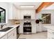Updated kitchen with white cabinets, subway tile backsplash, and stainless steel appliances at 3061 S Marion St, Englewood, CO 80113