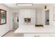 Bright kitchen featuring white cabinetry, breakfast bar with light quartz countertops, and stainless appliances at 3061 S Marion St, Englewood, CO 80113