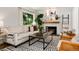 Cozy living room featuring a fireplace, stylish decor, comfortable seating, and a black-and-white patterned rug at 3061 S Marion St, Englewood, CO 80113