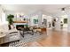 Open-concept living area with fireplace, modern decor, and seamless flow into the dining and kitchen spaces at 3061 S Marion St, Englewood, CO 80113