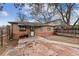 Brick home offers a charming backyard with mature trees and outdoor patio at 2259 Meade St, Denver, CO 80211