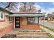Welcoming front porch area featuring a brick facade, colorful flower bed, and a 'Welcome' doormat at 2259 Meade St, Denver, CO 80211