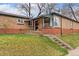 Inviting brick home showcasing a tidy front yard with steps leading to the front door at 2259 Meade St, Denver, CO 80211