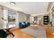 Sunlit living room features hardwood floors, modern decor, and a seamless flow into the dining space at 2259 Meade St, Denver, CO 80211