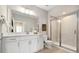 Well-lit bathroom with a large mirror, modern fixtures, and a glass-enclosed shower at 6111 W 28Th Ct, Wheat Ridge, CO 80214