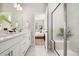 Bright bathroom boasts dual sinks, modern fixtures, and a glass-enclosed shower for a luxurious feel at 6111 W 28Th Ct, Wheat Ridge, CO 80214