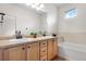 Double vanity bathroom with a bathtub and updated fixtures at 15945 E Geddes Dr # 54, Aurora, CO 80016
