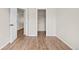 Bedroom with double-door closet and wood-look flooring at 15945 E Geddes Dr # 54, Aurora, CO 80016