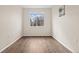 Empty bedroom featuring light walls and wood-look flooring at 15945 E Geddes Dr # 54, Aurora, CO 80016