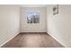 Empty bedroom with hardwood floors and a large window allowing plenty of light at 15945 E Geddes Dr # 54, Aurora, CO 80016