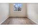 Bright bedroom with large window and wood-look flooring at 15945 E Geddes Dr # 54, Aurora, CO 80016