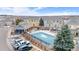 Community pool with a covered patio area and surrounding landscaping at 15945 E Geddes Dr # 54, Aurora, CO 80016
