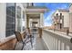 Inviting front porch with chairs and a small table, perfect for relaxing at 15945 E Geddes Dr # 54, Aurora, CO 80016