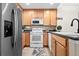 Well-equipped kitchen featuring stainless steel appliances and ample cabinetry at 15945 E Geddes Dr # 54, Aurora, CO 80016