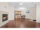 Living room with fireplace, kitchen, and hardwood floors at 15945 E Geddes Dr # 54, Aurora, CO 80016