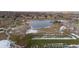 Community aerial view showing large pond surrounded by grass and a view of the neighborhood at 5747 S Lowell Blvd, Littleton, CO 80123