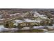 Aerial view of a golf course with scattered snow cover showing sand traps and the surrounding landscape at 5747 S Lowell Blvd, Littleton, CO 80123