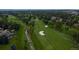 Aerial view of a lush golf course with scenic stream and mature trees winding through the green at 5747 S Lowell Blvd, Littleton, CO 80123