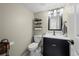 Half bathroom featuring stylish vanity, modern fixtures, and neutral tones at 5747 S Lowell Blvd, Littleton, CO 80123