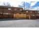 Townhome exterior showing a gated backyard, rear of the building, and parking area at 5747 S Lowell Blvd, Littleton, CO 80123