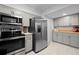 Updated kitchen featuring stainless steel appliances and gray cabinets at 5747 S Lowell Blvd, Littleton, CO 80123