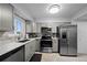 Well-equipped kitchen featuring stainless steel appliances and gray cabinetry at 5747 S Lowell Blvd, Littleton, CO 80123