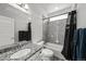 Modern bathroom with a shower-tub combo, gray tiled walls, and granite countertop at 14632 Longhorn Dr, Mead, CO 80542