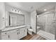 Bright bathroom with a large mirror, granite countertop, and glass door shower at 14632 Longhorn Dr, Mead, CO 80542