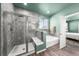 Bathroom featuring a glass shower, soaker tub, and a door leading to the bedroom at 14632 Longhorn Dr, Mead, CO 80542