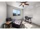 Cozy bedroom with a ceiling fan, an ottoman, and a window that offers a street view at 14632 Longhorn Dr, Mead, CO 80542