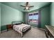 Charming bedroom with a ceiling fan, carpet floors, and ample natural light from the window at 14632 Longhorn Dr, Mead, CO 80542