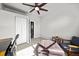 Bright bedroom featuring neutral decor, a ceiling fan, and natural light from a large window at 14632 Longhorn Dr, Mead, CO 80542