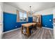 Bright dining room with hardwood floors, a modern chandelier, and a large window at 14632 Longhorn Dr, Mead, CO 80542