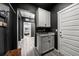 Stylish hallway featuring modern lighting, a cabinet with a granite countertop, and a view into another room at 14632 Longhorn Dr, Mead, CO 80542