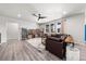 Bright living room with hardwood floors, a modern ceiling fan, and ample natural light at 14632 Longhorn Dr, Mead, CO 80542