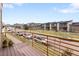View from balcony overlooking a green space, street, and neighboring townhomes at 10051 Belvedere Cir, Lone Tree, CO 80124