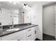 Well-lit bathroom with double sinks, granite countertop, and a separate shower at 10051 Belvedere Cir, Lone Tree, CO 80124