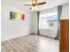 Bright bedroom with laminate flooring, large window, modern ceiling fan and neutral wall color at 10051 Belvedere Cir, Lone Tree, CO 80124
