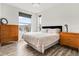 Cozy bedroom with wood floors, natural light, dresser and modern decor at 10051 Belvedere Cir, Lone Tree, CO 80124