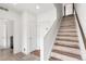 Bright hallway with stairs and multiple doors, offering a modern and functional design at 10051 Belvedere Cir, Lone Tree, CO 80124