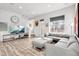 Comfortable living room with modern decor, a large sectional sofa, and a view of the staircase at 10051 Belvedere Cir, Lone Tree, CO 80124