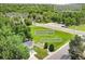 Aerial view of a well-maintained home with custom garden and patio, located near a trail and creek at 10869 W 65Th Way, Arvada, CO 80004