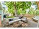 Backyard deck with outdoor seating and dining furniture is framed by mature trees at 10869 W 65Th Way, Arvada, CO 80004