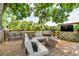 Large outdoor deck features a cozy seating area, dining space, and an outdoor TV for relaxing entertainment at 10869 W 65Th Way, Arvada, CO 80004