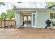 View of the home's back deck with double doors opening to the living room and a grill at 10869 W 65Th Way, Arvada, CO 80004